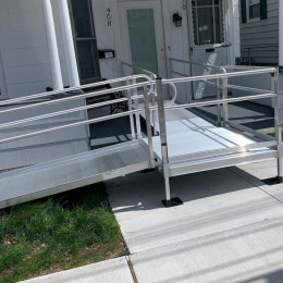 An EZ-ACCESS wheelchair ramp leading to a front door of a Brockton MA home
